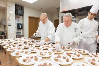 Chefs Bruce Mattel and Mark Elia preparing sample plates for a seminar. Photo courtesy of CIA.
