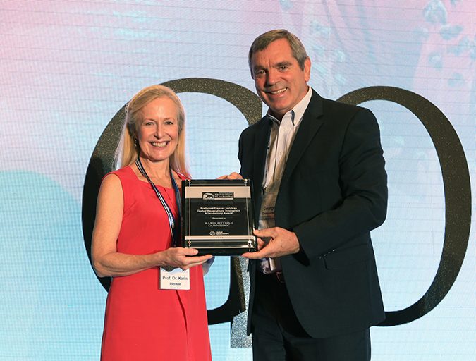 University of Bergen Professor Karin Pittman accepts the Global Aquaculture Innovation & Leadership Award from George Chamberlain, president of the Global Aquaculture Alliance. 